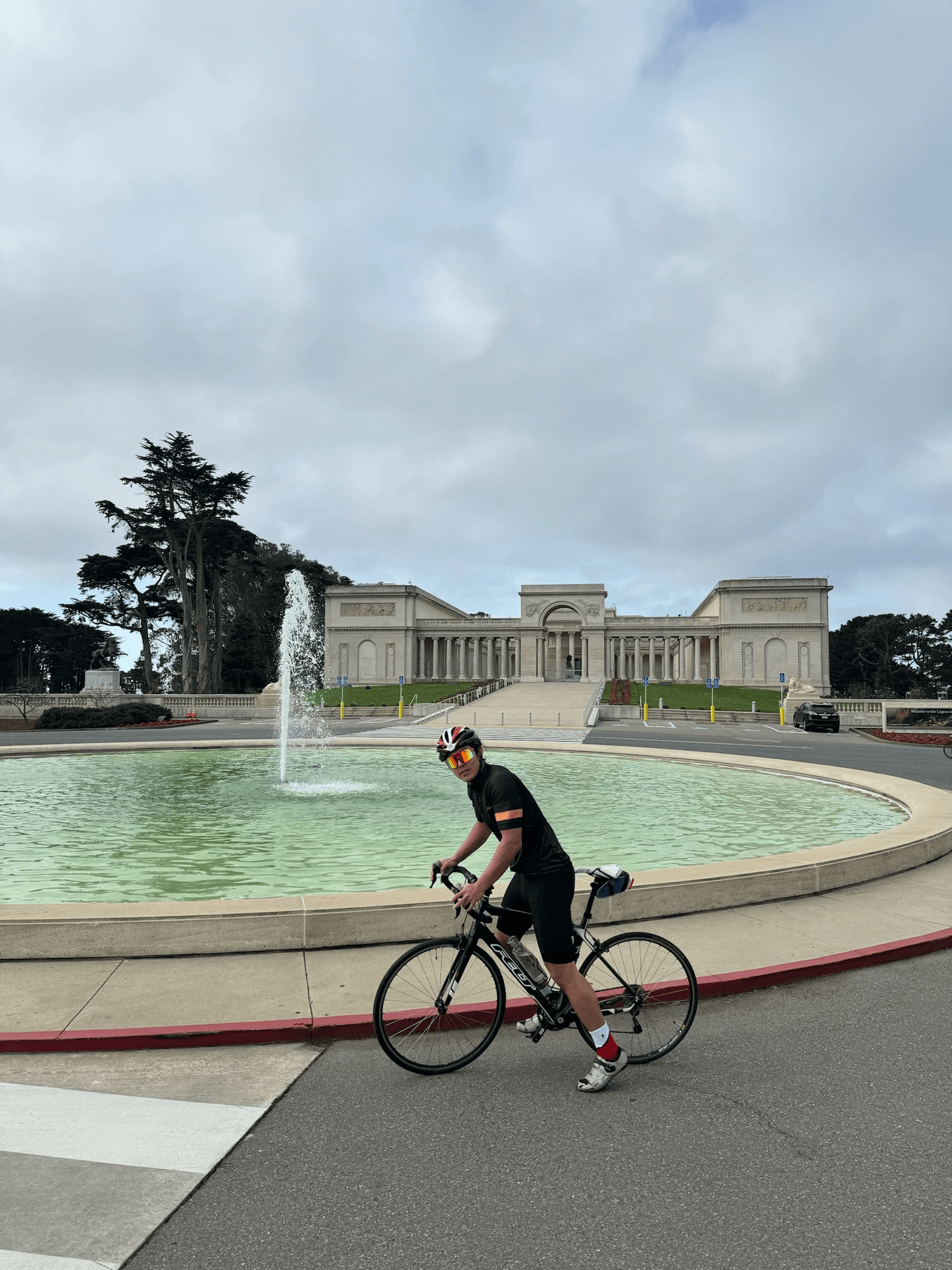 Dennis biking near a rounded concrete structure